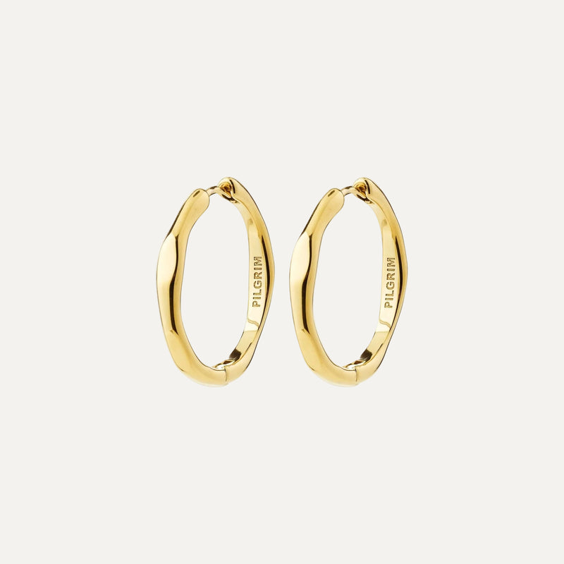 A pair of gold-plated wavy hoop earrings with the brand name 'PILGRIM' engraved on the inside, shown against a plain white background.