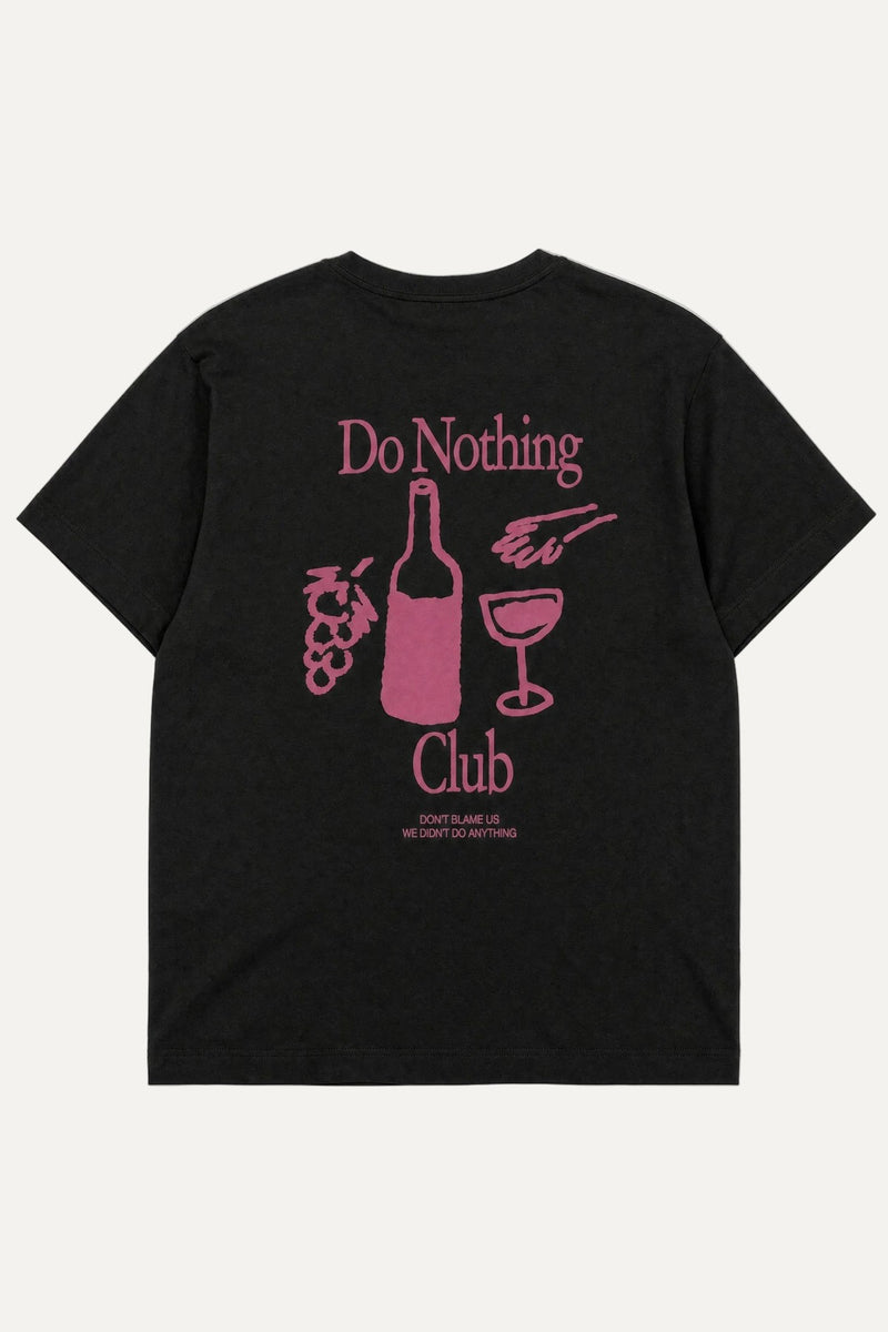 A black short-sleeve t-shirt with a pink graphic print on the back. The graphic features the text 'Do Nothing Club' surrounding illustrations of a wine bottle, a wine glass, grapes, and a hand holding a glass.