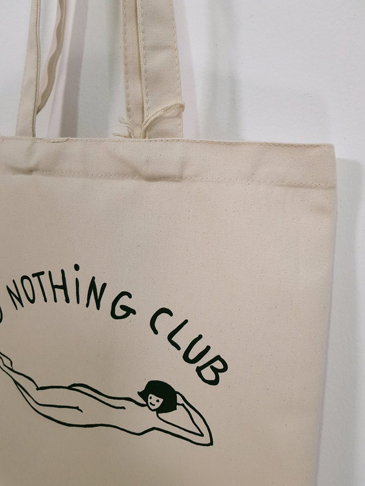 DO Nothing girl organic cotton premium tote bag te koop in de webshop van Almost Summer Amsterdam